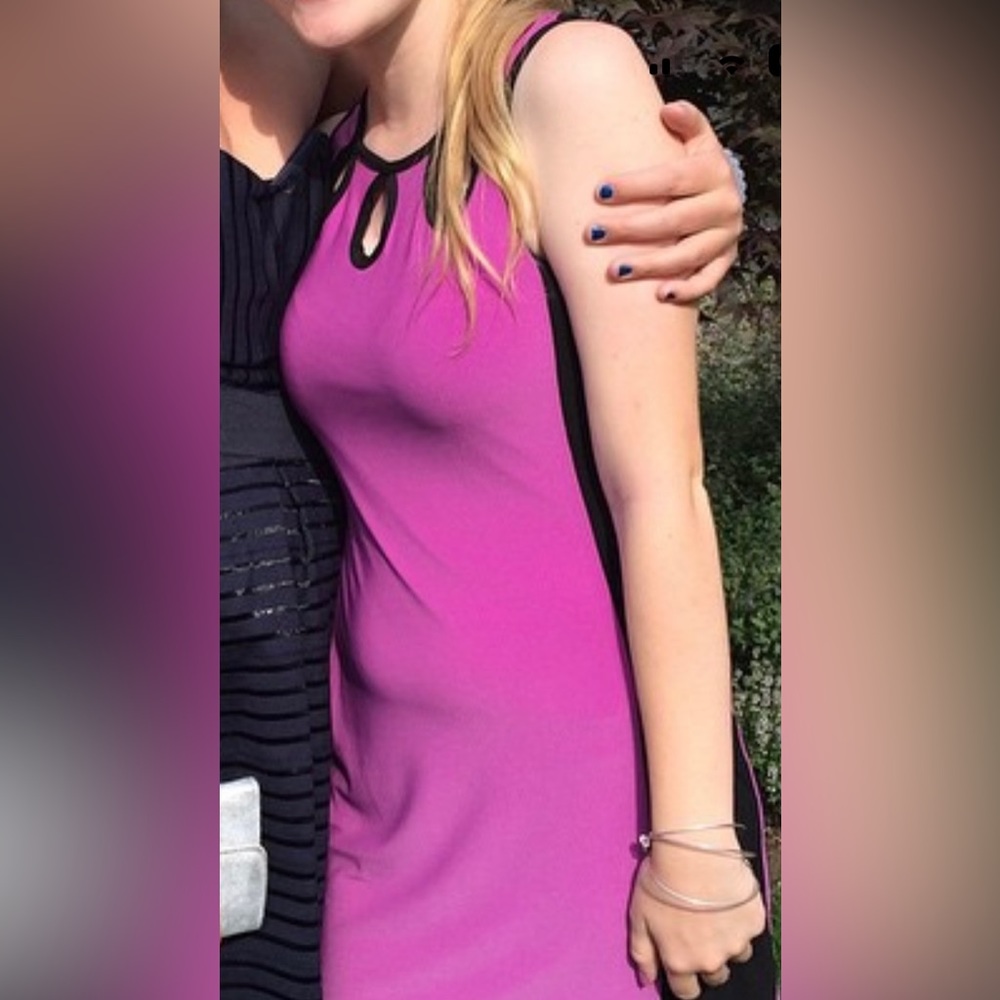 purple dress with black sides and three key hole cutouts in neckline